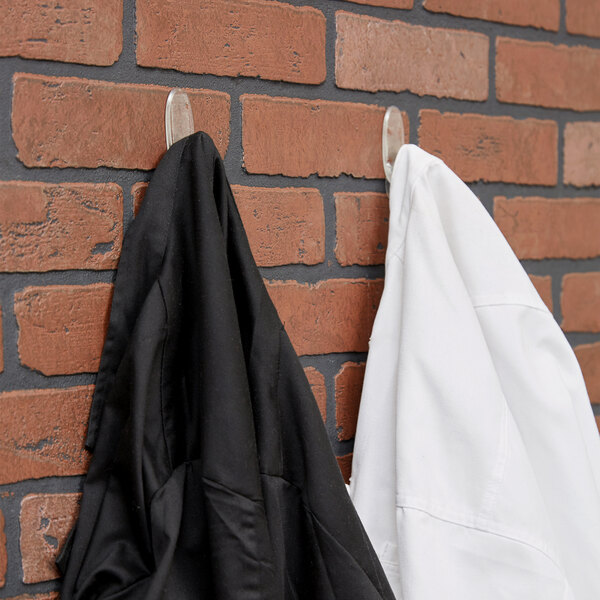 a black and white coat on hooks