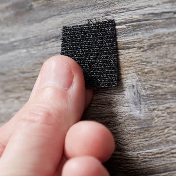 a person holding a piece of fabric