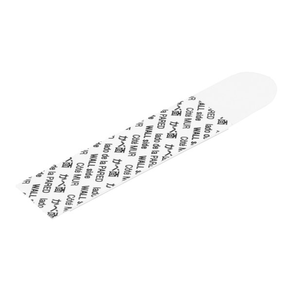 A white adhesive strip labeled with 'WALL side' and translations in multiple languages, used for mounting Command hooks.