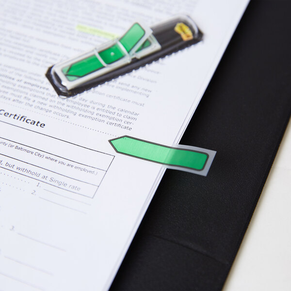 A piece of paper with a green "Sign Here" Post-It flag on it.