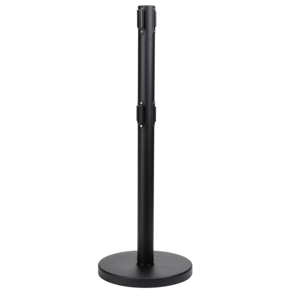 A black metal Aarco crowd control stanchion with a round base and black pole.