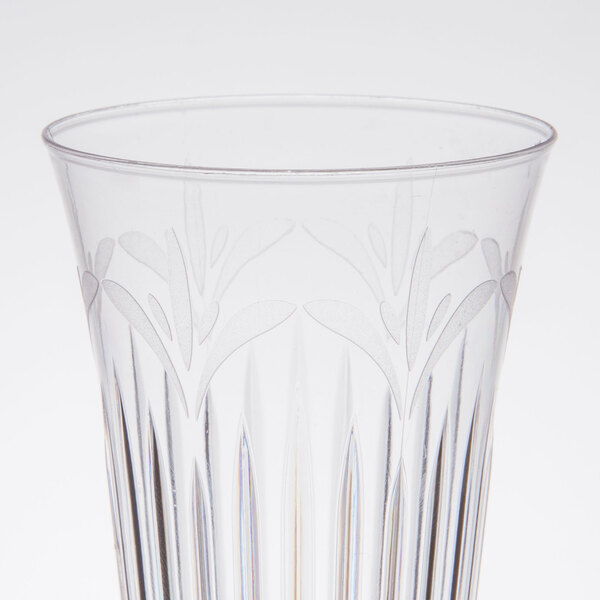A clear plastic champagne flute with a design on it.