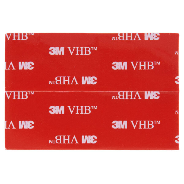 A red rectangular 3M adhesive strip with white text on it.