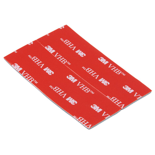 A red rectangular 3M Scotch mounting strip with white text.