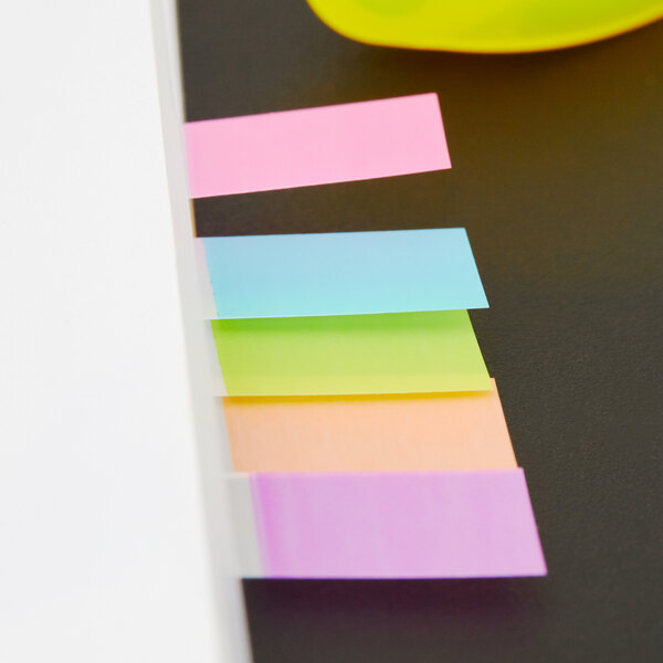 A yellow plastic egg with several colorful Post-It Page Flags inside.