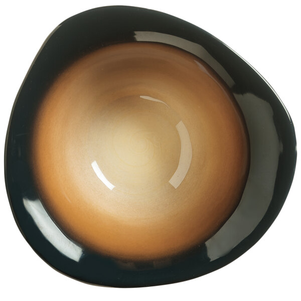 A close-up of a brown and black ribbed porcelain bowl with a white curved edge.