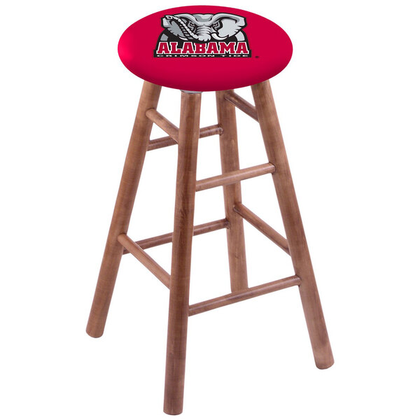 A wooden Holland Bar Stool with a University of Alabama logo on the seat.