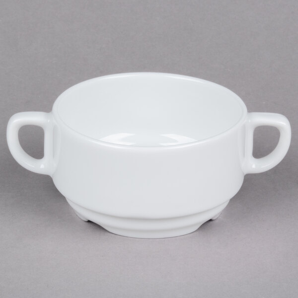 A white bowl with two handles.