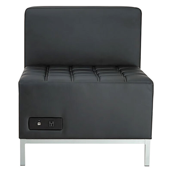 A black armless sectional with a power outlet.
