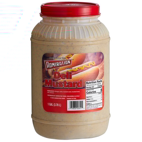 A case of four gallon containers of Admiration Deli Mustard on a table with a hot dog.