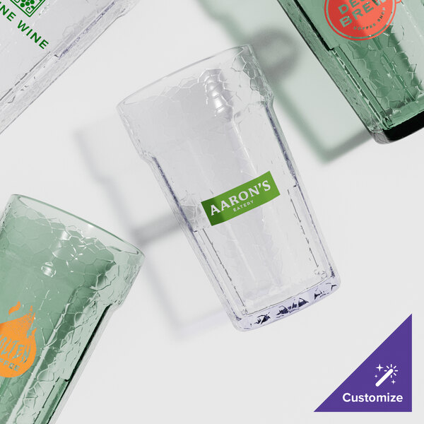 A group of Cambro plastic tumblers with a green label on one.