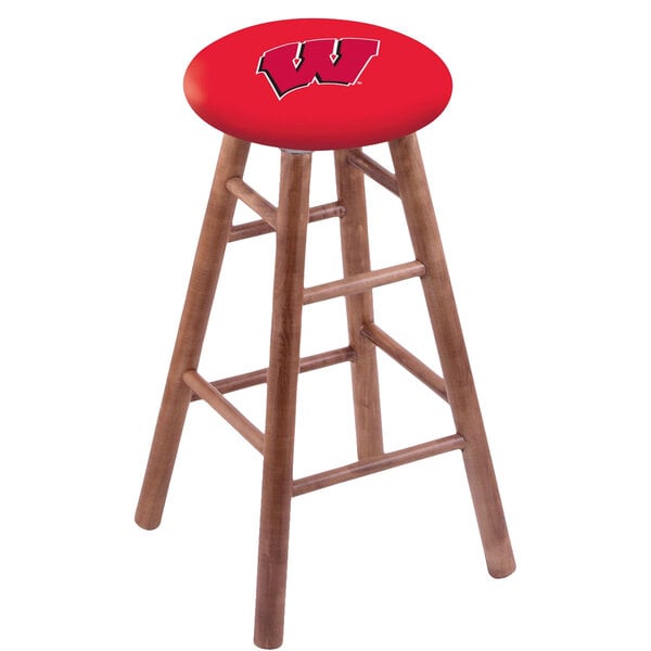 A University of Wisconsin bar stool with a red seat and white logo.