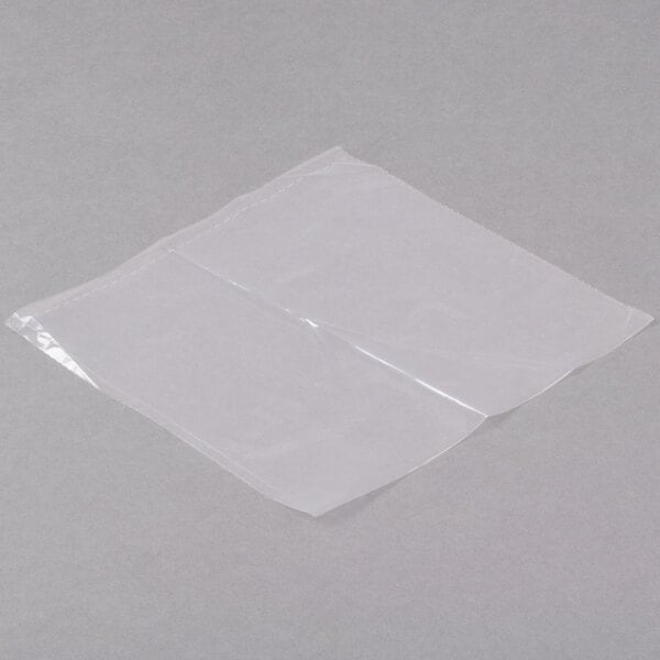 A roll of LK Packaging clear plastic sandwich bags with white writing on a gray surface.