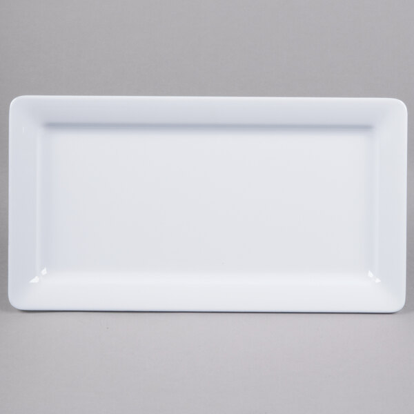 A white rectangular melamine serving platter with a white rim.