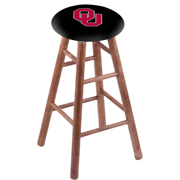 A Holland Bar Stool wooden bar stool with a black seat and the University of Oklahoma logo in red.