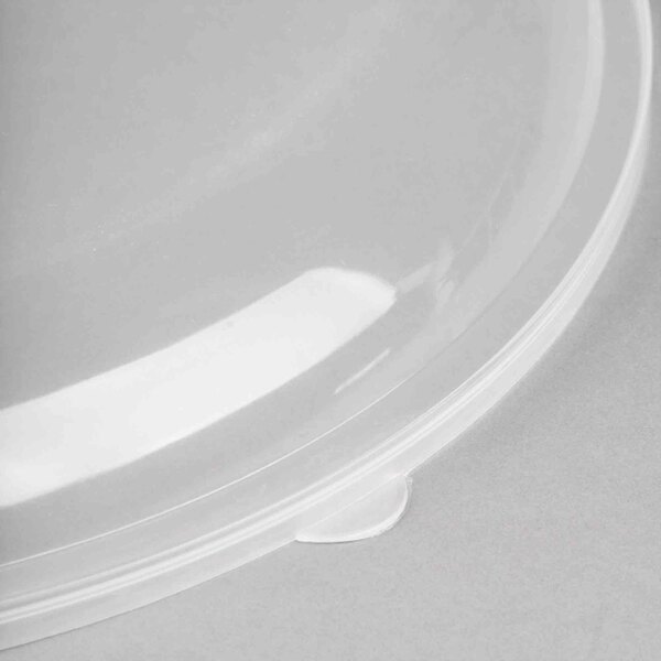 A clear plastic lid with a small hole in it.