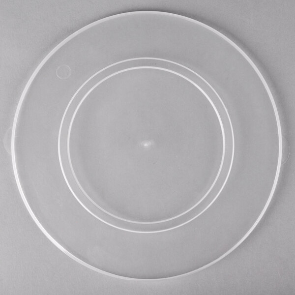 A clear plastic lid with a circular rim on a clear plastic container.