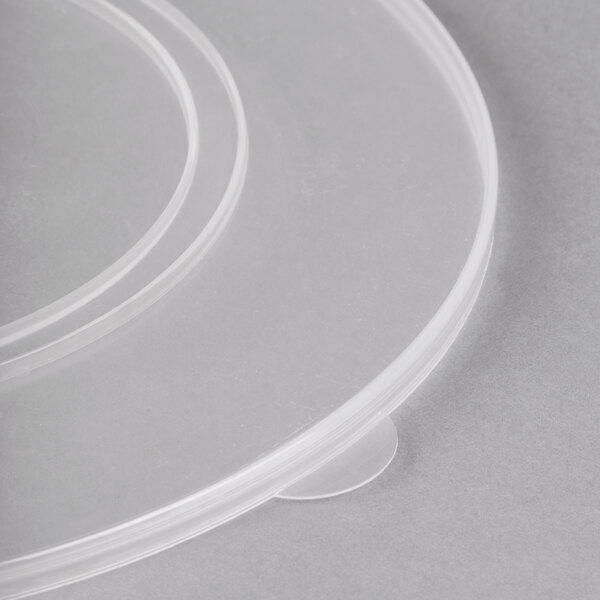 A clear plastic lid with two circular cutouts on a white background.