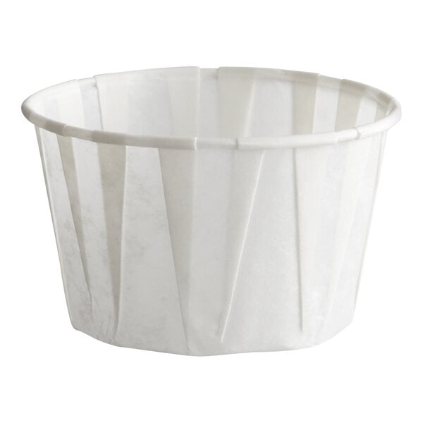 A small white paper souffle or portion cup with a 2.5 oz. capacity.