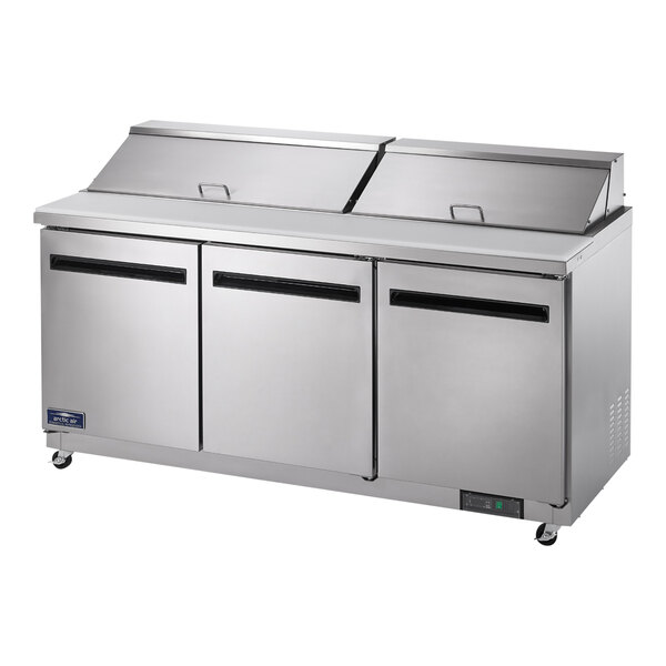 An Arctic Air 3 door refrigerated sandwich prep table on a counter.