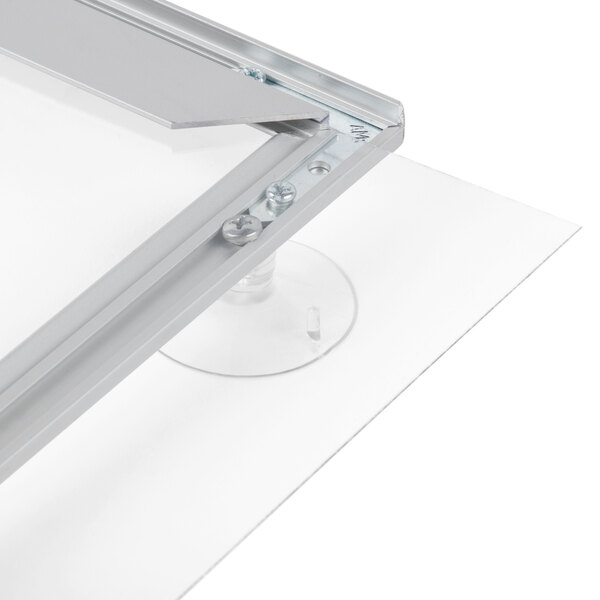 An Aarco aluminum window mount slide frame on a glass window.
