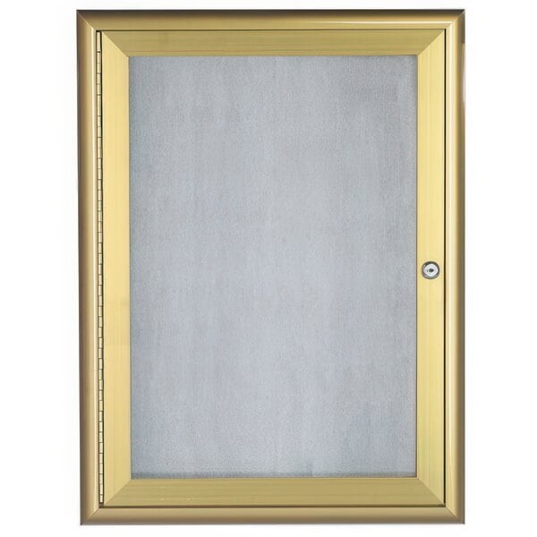 A gold framed glass cabinet door with a white background.