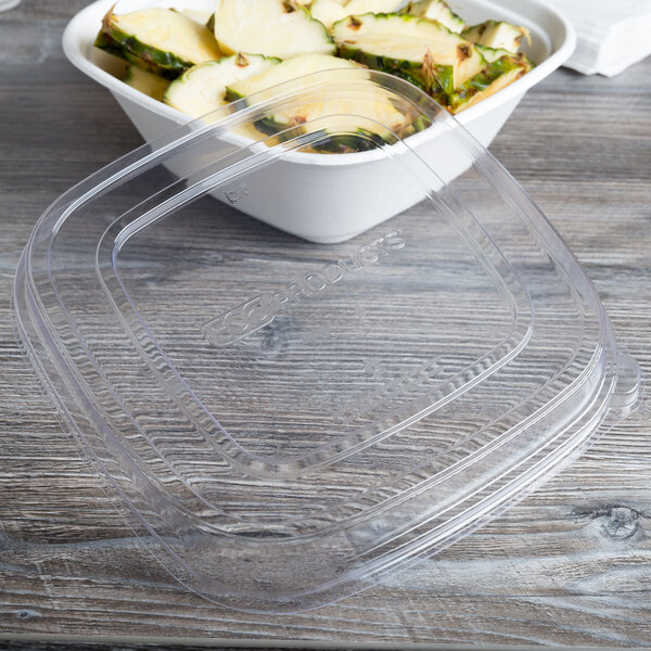 A clear plastic bowl with a clear plastic lid filled with food.