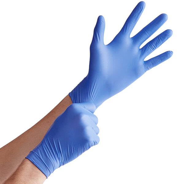 a pair of hands wearing blue gloves