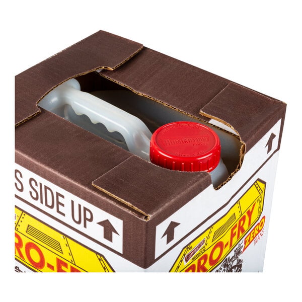 A partially opened cardboard box reveals a plastic container with a red cap and a handle inside.