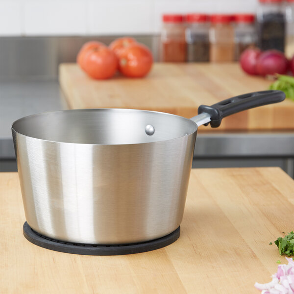 A Vollrath stainless steel sauce pan on a counter.