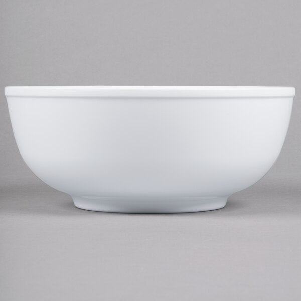 A close-up of a white Thunder Group melamine pho noodle bowl.