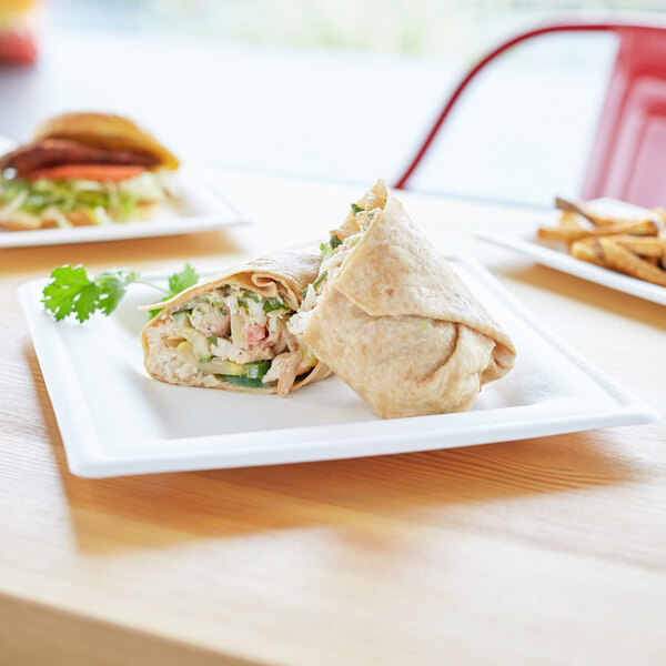 A Eco-Products white compostable plate with a burrito on it.