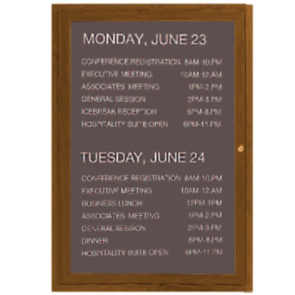 An Aarco outdoor directory board with oak finish and white text on black board.