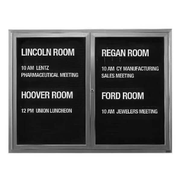 An Aarco enclosed black letter board sign with white text that says "Lincoln Room" on it.