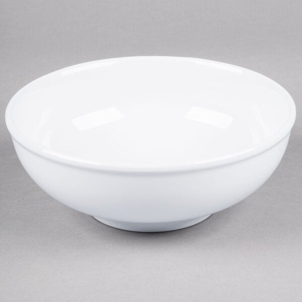 A white Thunder Group melamine pho noodle bowl with a white rim on a gray surface.