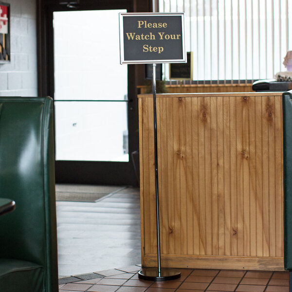 A Chef Master hostess/teller sign on a stand in a restaurant.