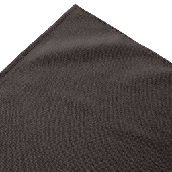 A charcoal box pleat table skirt on a table with velcro clips.