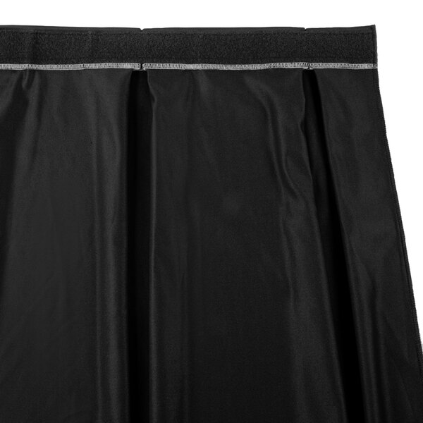 A black table skirt with a black box pleat band.