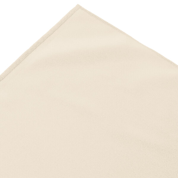 A bone box pleat table skirt with a corner on a white surface.