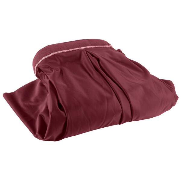 A burgundy Snap Drape table skirt in a bag with a white stripe and zipper.