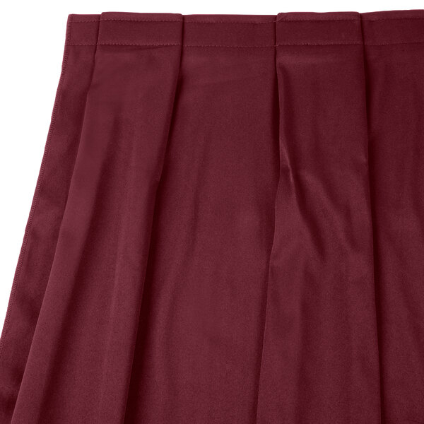 A burgundy box pleat table skirt with velcro clips.
