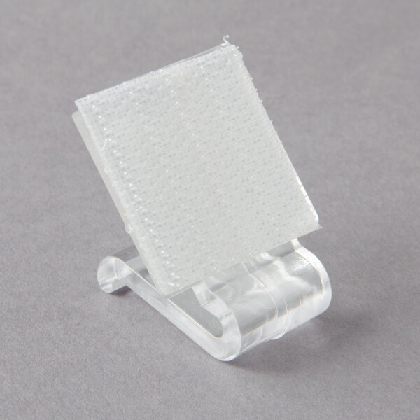 A close-up of a clear plastic object with a white surface.