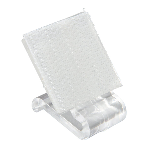 A clear plastic Velcro clip designed for attaching table skirts to tables.