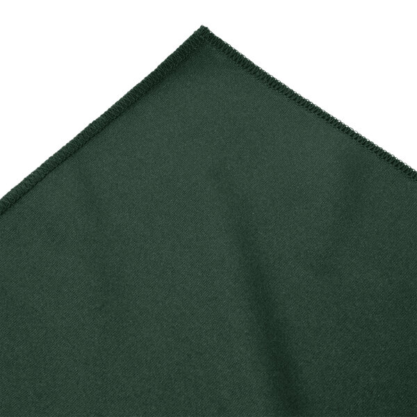 A close-up of a green fabric with a white edge.