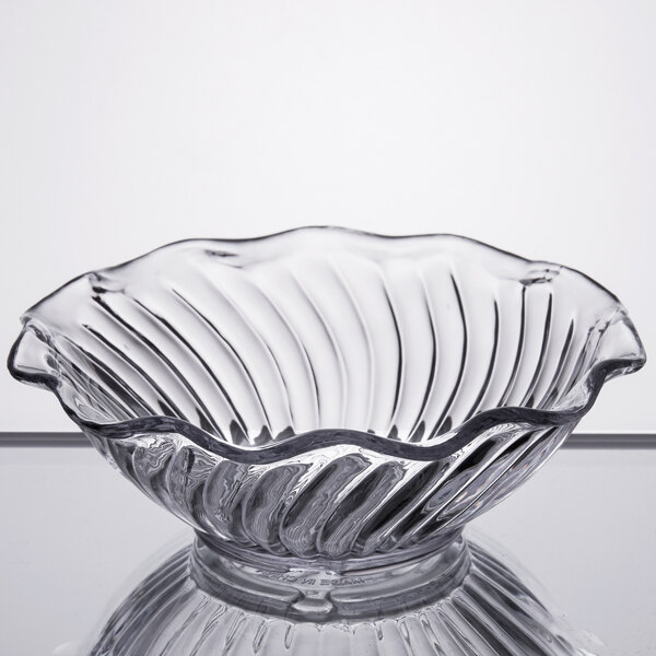 A clear glass GET dessert dish with a wavy edge.