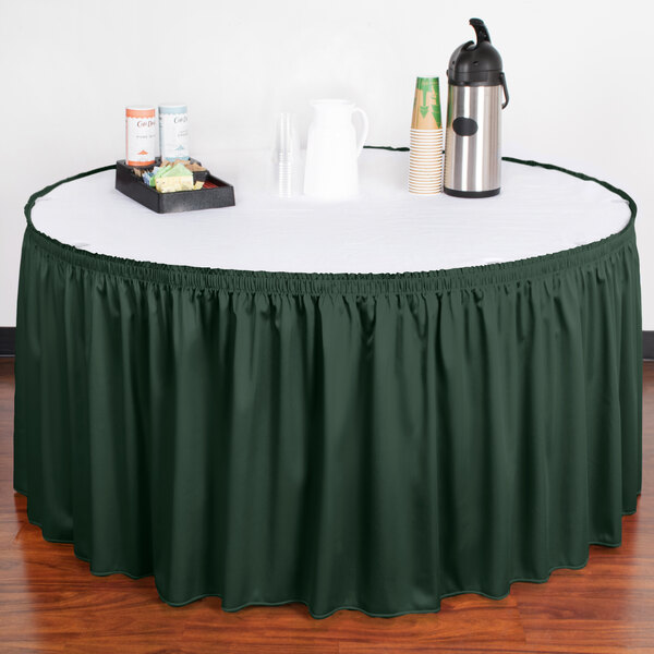A table with a Snap Drape Jade table skirt with Velcro clips.