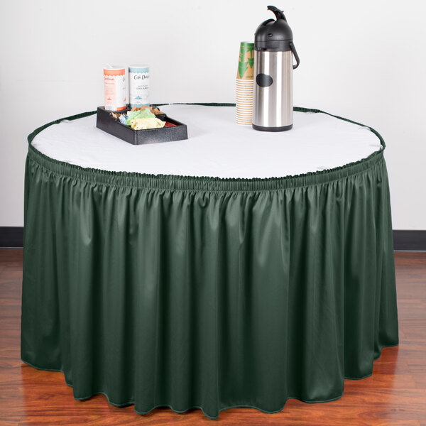 A table with a green Snap Drape table skirt.