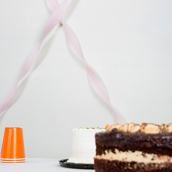 A table with a Classic Pink Streamer Paper ribbon on it.