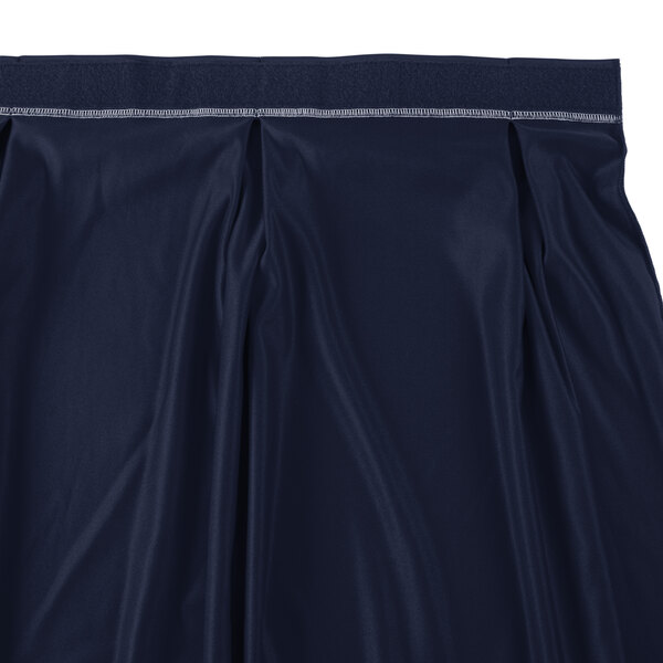 A navy Snap Drape table skirt with a pleated hem and Velcro clips.