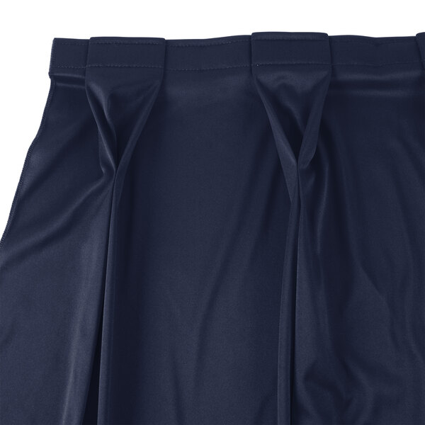 A close up of a navy Snap Drape Wyndham bow tie pleat table skirt.